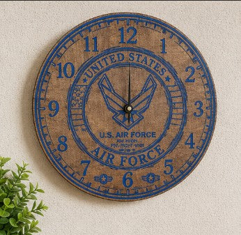 Wooden wall clock with U.S. Air Force emblem and text on a beige wall.