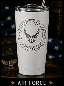 White tumbler with U.S. Air Force logo on a wooden surface with American flag in the background