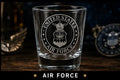 Glass with 'United States Air Force' engraving on a wooden surface