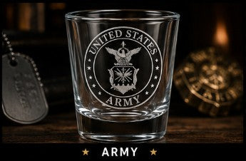 Glass with 'United States Army' engraving on a wooden surface with military-themed decor.