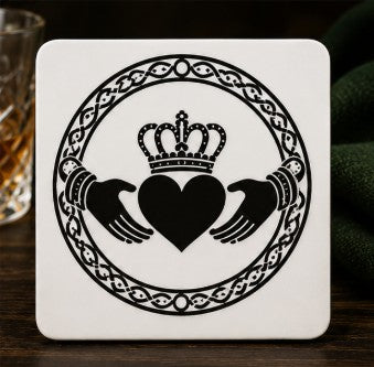 Coaster with Claddagh design on a dark surface
