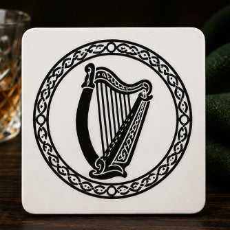 Coaster with harp design on a wooden surface