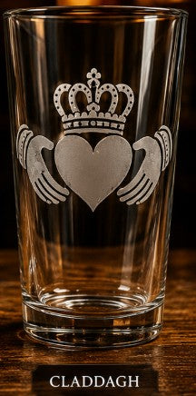 Clear glass with Claddagh design on a wooden surface