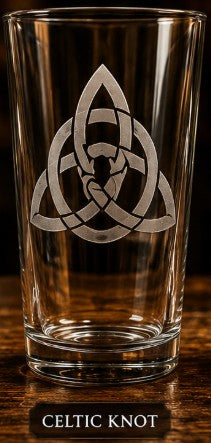 Clear glass with Celtic knot design on a wooden surface