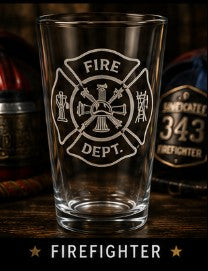 Pint glass with 'Fire Dept.' emblem on a wooden surface with bottles in the background