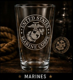 Clear glass with United States Marine Corps emblem on a wooden surface