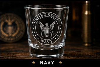 Clear glass with U.S. Navy emblem on a wooden surface